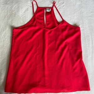 Red flowy tank top with spaghetti straps.